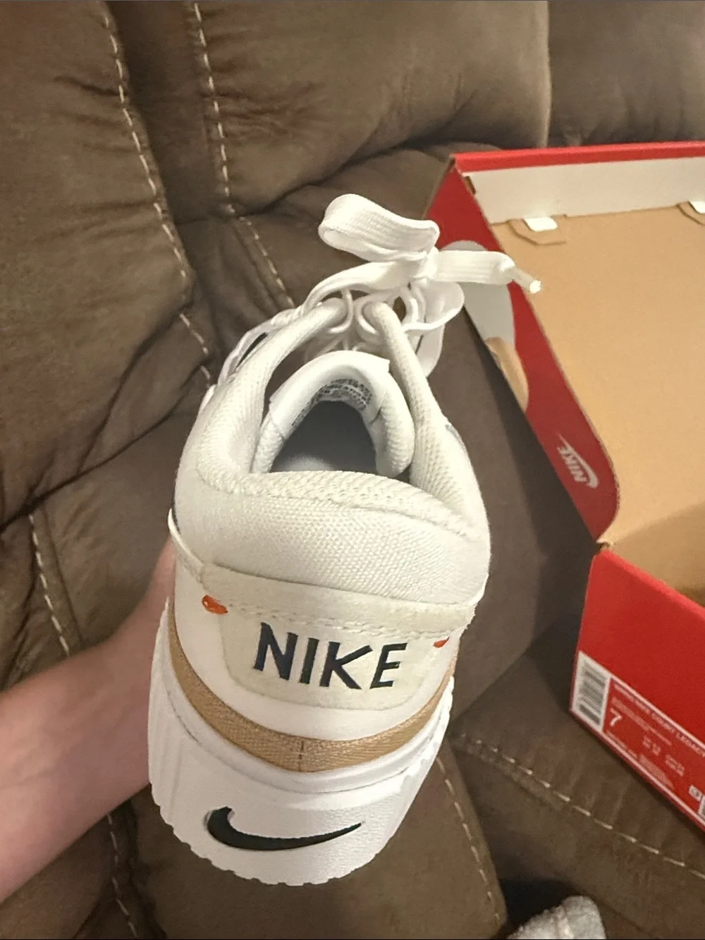 Nike Women's White Sneakers with Black Swoosh and Tan Stripe